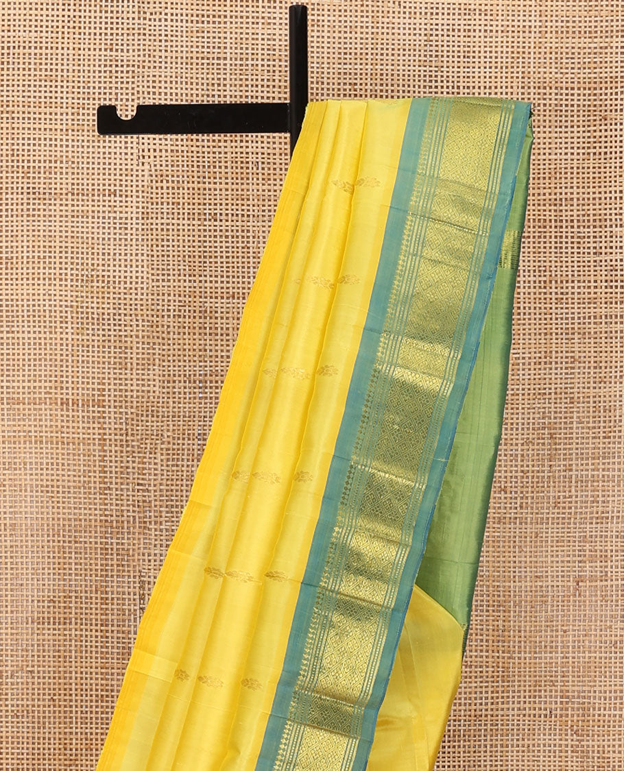 Yellow Kanchipuram silk saree with zari buttas, contrast one-sided border of panner sombu,banaras,muthu & jaal & zari design pallu