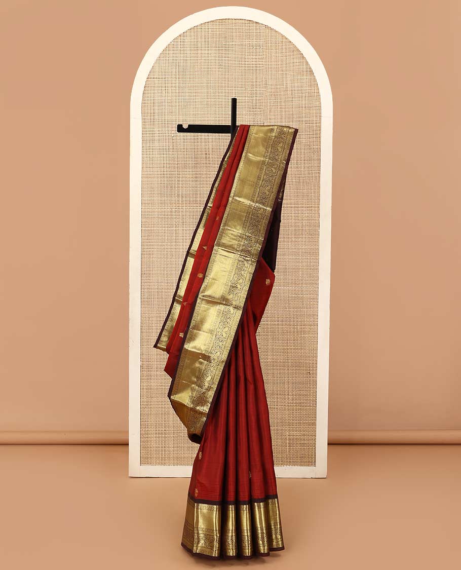 Rust zari buttas Kanchipuram silk saree, contrast border of thilakam mokku, muthu, poun, mayil kann, and manga designs, and zari design pallu