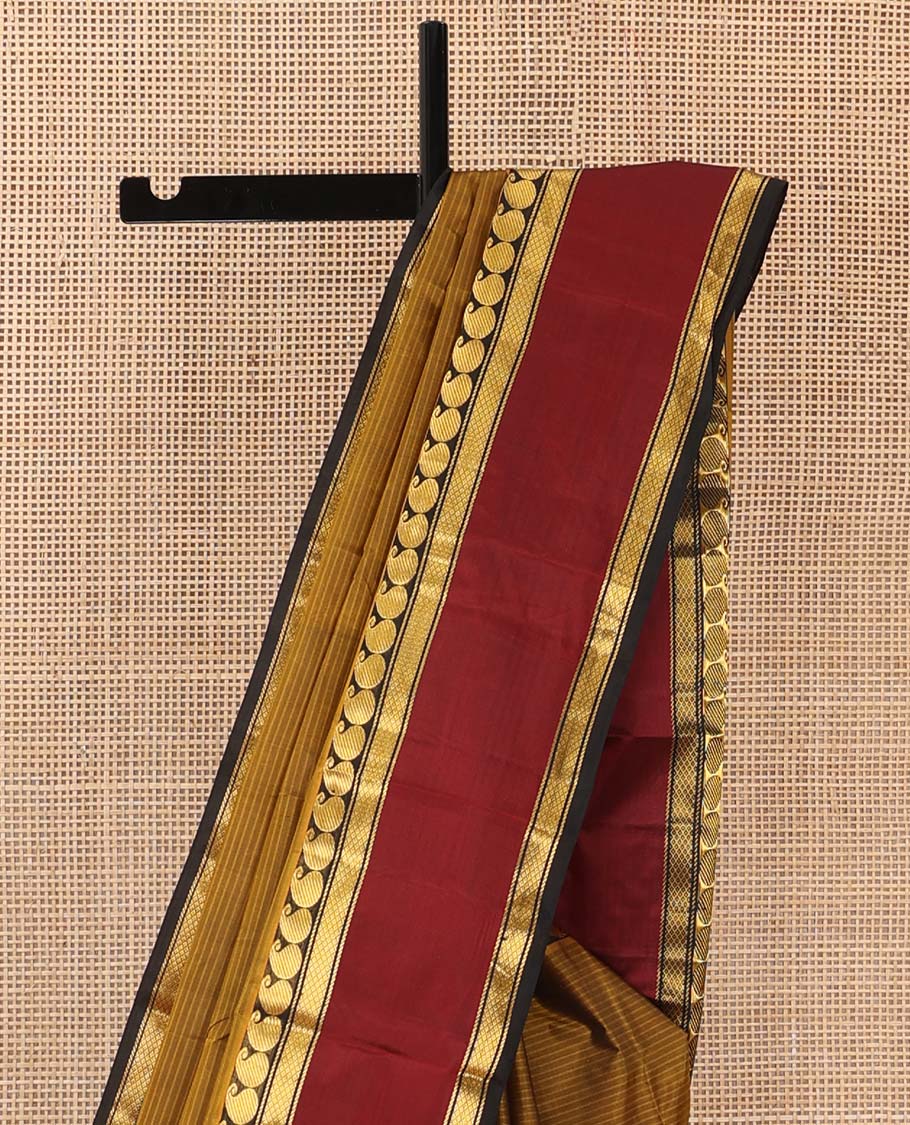 Mustard striped Kanchipuram silk saree, contrast rettai pettu border of manga and mayil kann designs, and zari striped pallu