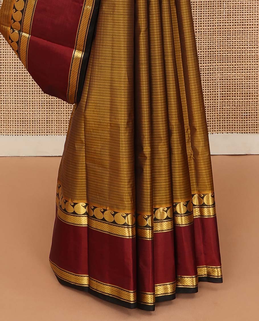 Mustard striped Kanchipuram silk saree, contrast rettai pettu border of manga and mayil kann designs, and zari striped pallu