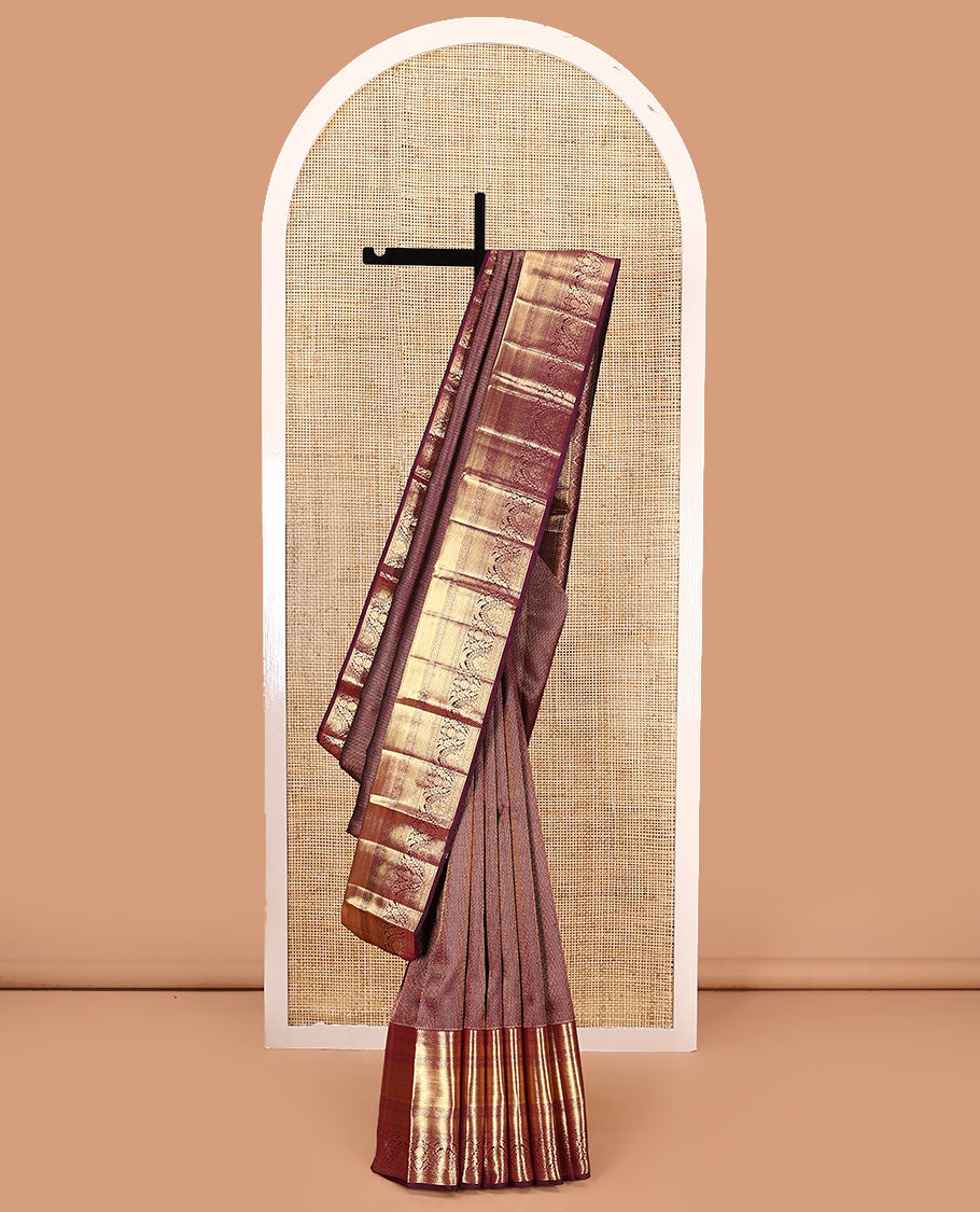 Maroon jacquard kanchipuram silk saree, zari border of traditional zari designs, and zari-rich pallu