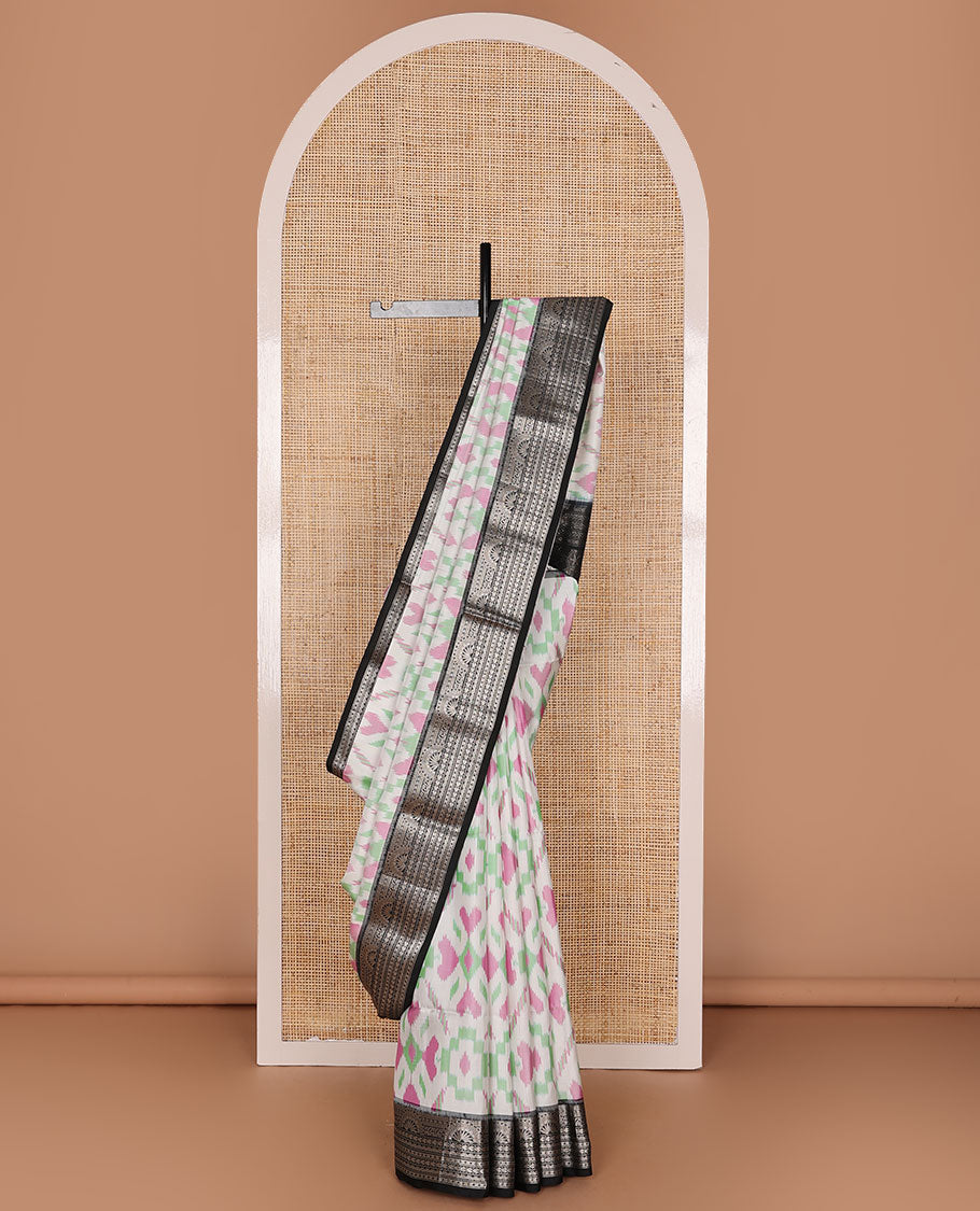 Half-white colorful jaal-patterned pure ikkat saree, contrast traditional zari design black border & pallu of geometric zari designs