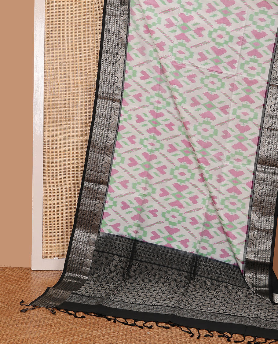 Half-white colorful jaal-patterned pure ikkat saree, contrast traditional zari design black border & pallu of geometric zari designs