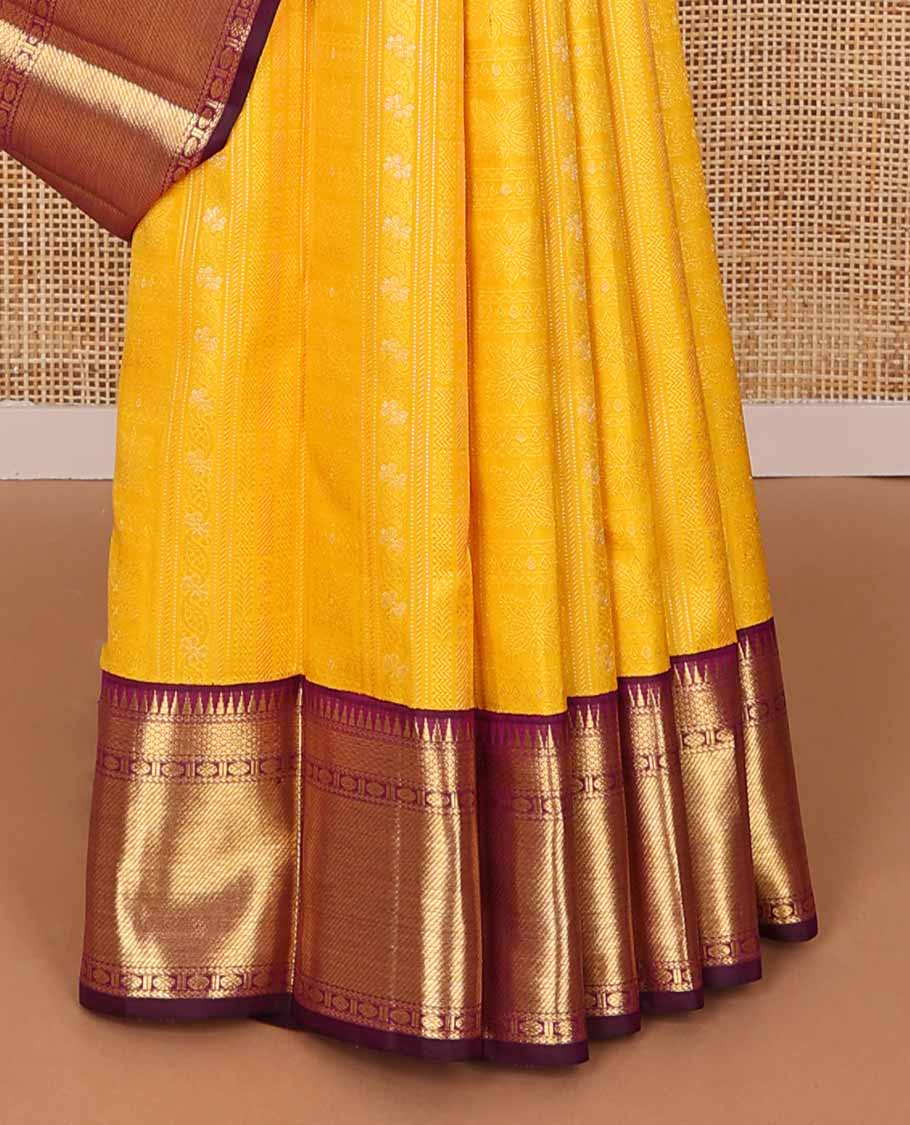 Yellow floral design silk saree with contrast border of rekku, paun, mayil kann design & jaal design pallu