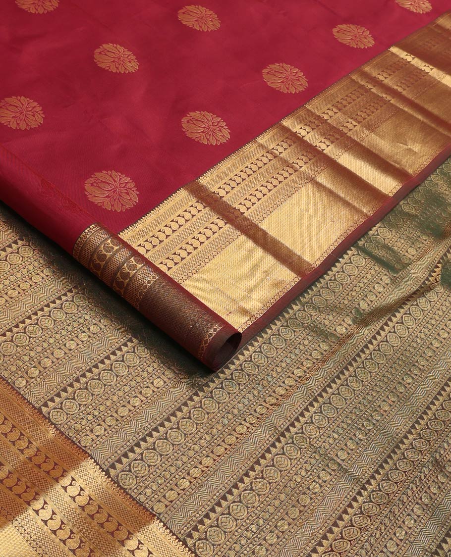 Maroon zari buttas Vasundhara silk mix saree, contrast border of thilakam, mayil kann, diamond, and manga designs, and geometric patterned pallu