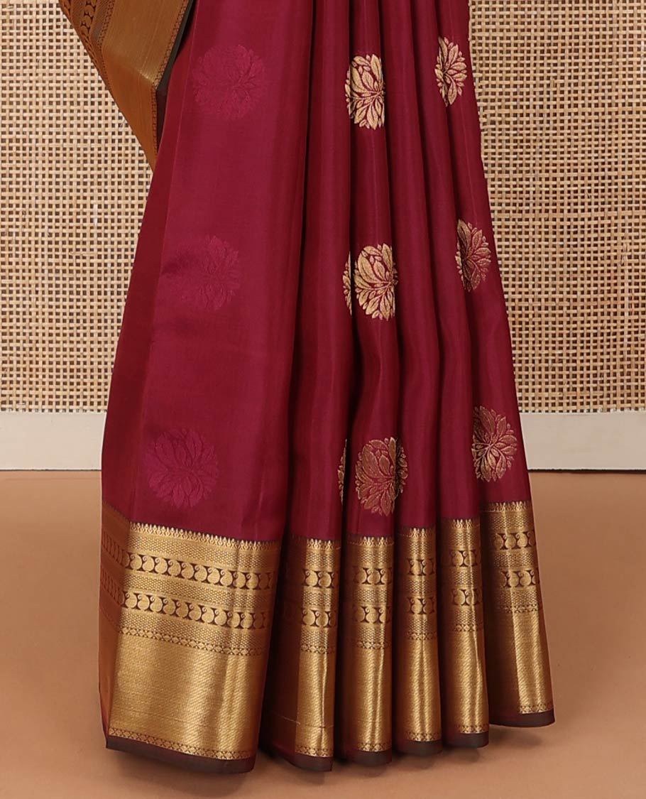 Maroon zari buttas Vasundhara silk mix saree, contrast border of thilakam, mayil kann, diamond, and manga designs, and geometric patterned pallu