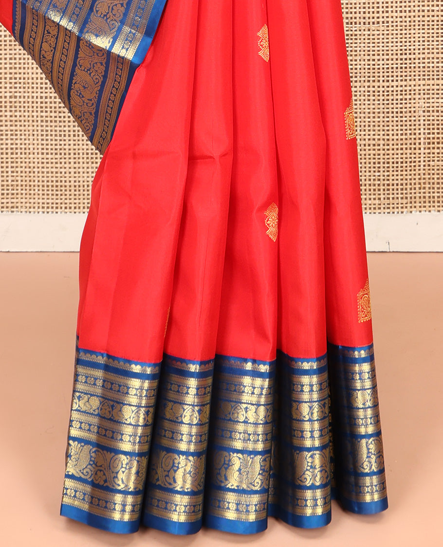 Orange Vasundhara Silk Saree, Subtly Sparkled With Zari Buttas All Over Its Body, Complemented by Contrast Border of Salngai, Muthu, Kamalam, Jada Nagam, and Mayil Designs, Grand Pallu and Paired with a Contrast Blouse