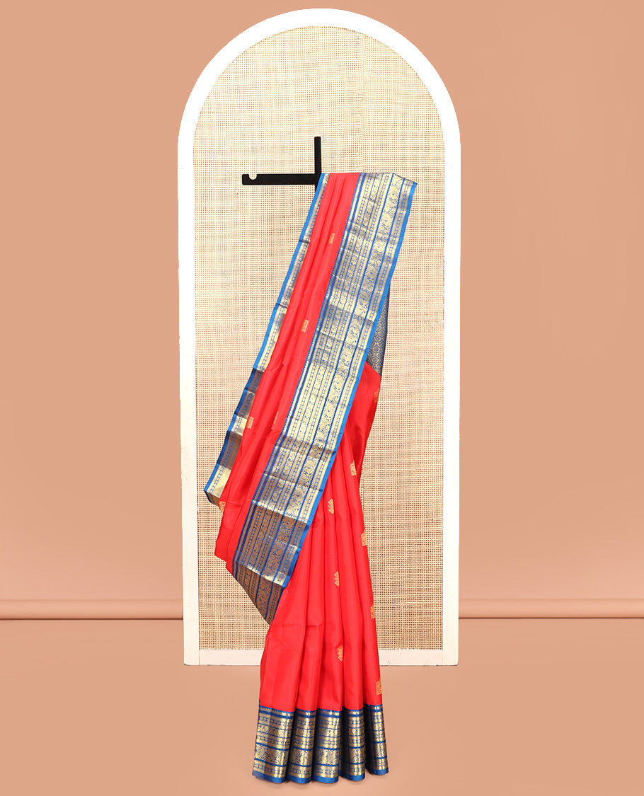 Orange Vasundhara Silk Saree, Subtly Sparkled With Zari Buttas All Over Its Body, Complemented by Contrast Border of Salngai, Muthu, Kamalam, Jada Nagam, and Mayil Designs, Grand Pallu and Paired with a Contrast Blouse