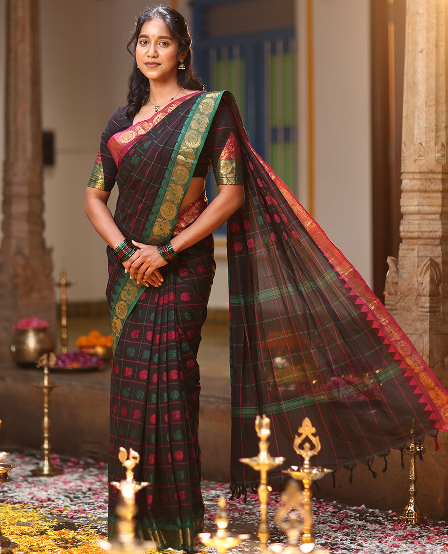Black Chettinad Cotton Saree Features Butta Enclosed Checks, a Contrast Temple Annam-Peacock Ganga-Jamuna Border, and a Matching Blouse