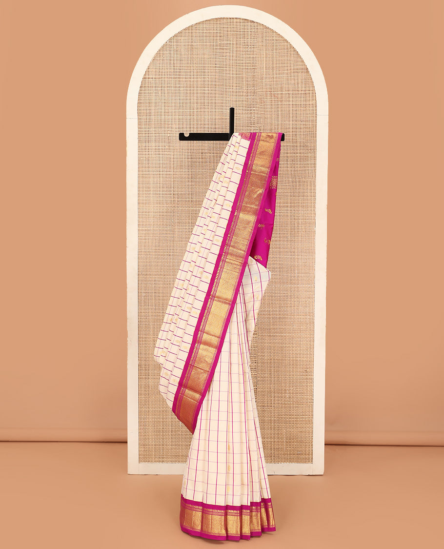Cream kamalam zari buttas with checked Kanchipuram silk saree, contrast korvai border of thilakam mokku, banaras, and mayil kann designs, and zari design pallu