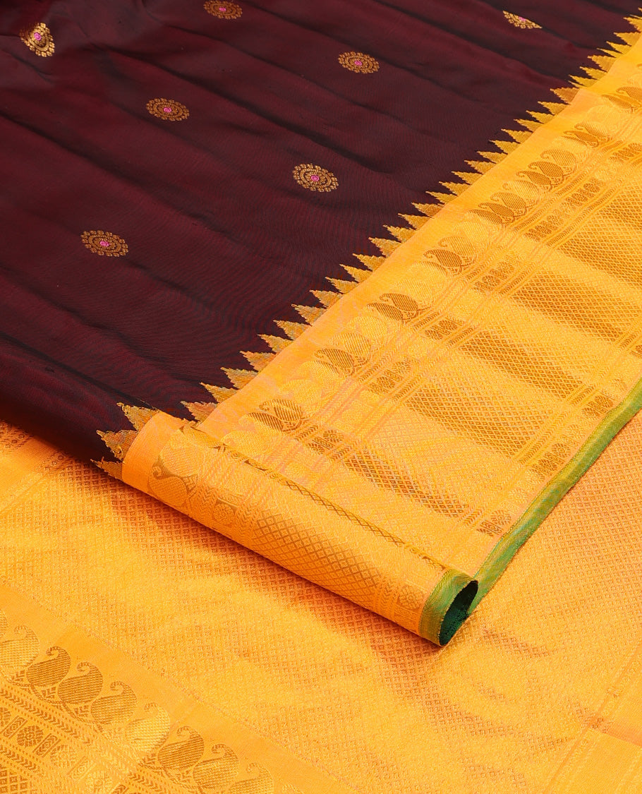 Maroon meena chakram buttas gadwal silk saree, contrast thazampoo rekku border of manga mokku, kathir, laddu kamalam, and mayil kann designs