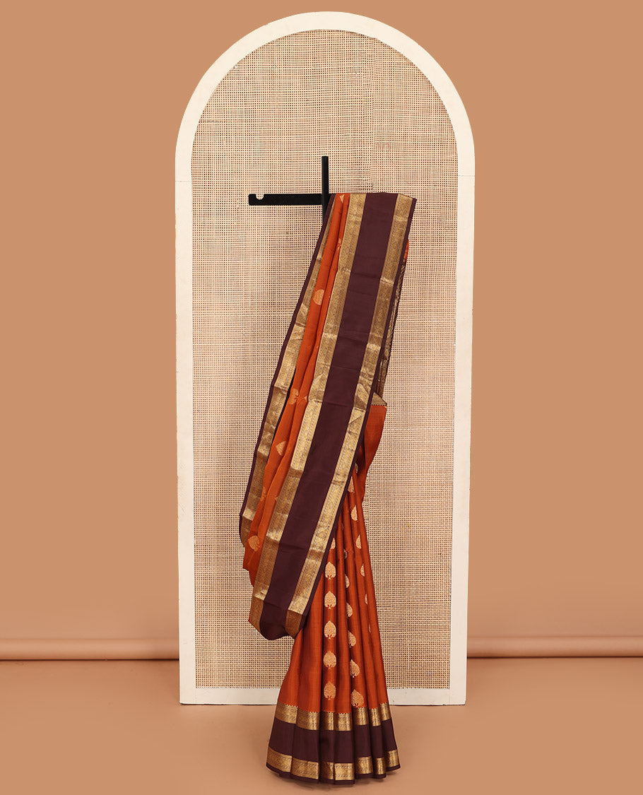 Orange zari buttas Kanchipuram silk saree, contrast rettai pettu border of kathir, jada nagam, and Greek key designs, and zari-rich pallu