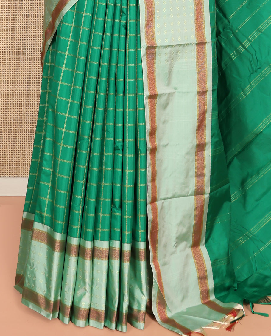 Green Aarani Silk Saree, Spotlighted with Zari Medium-Sized Checked All Over Its Body, Complemented by a Contrast Zari Buttas Woven Border, Pallu of Stripes, and Paired with a Matching Blouse