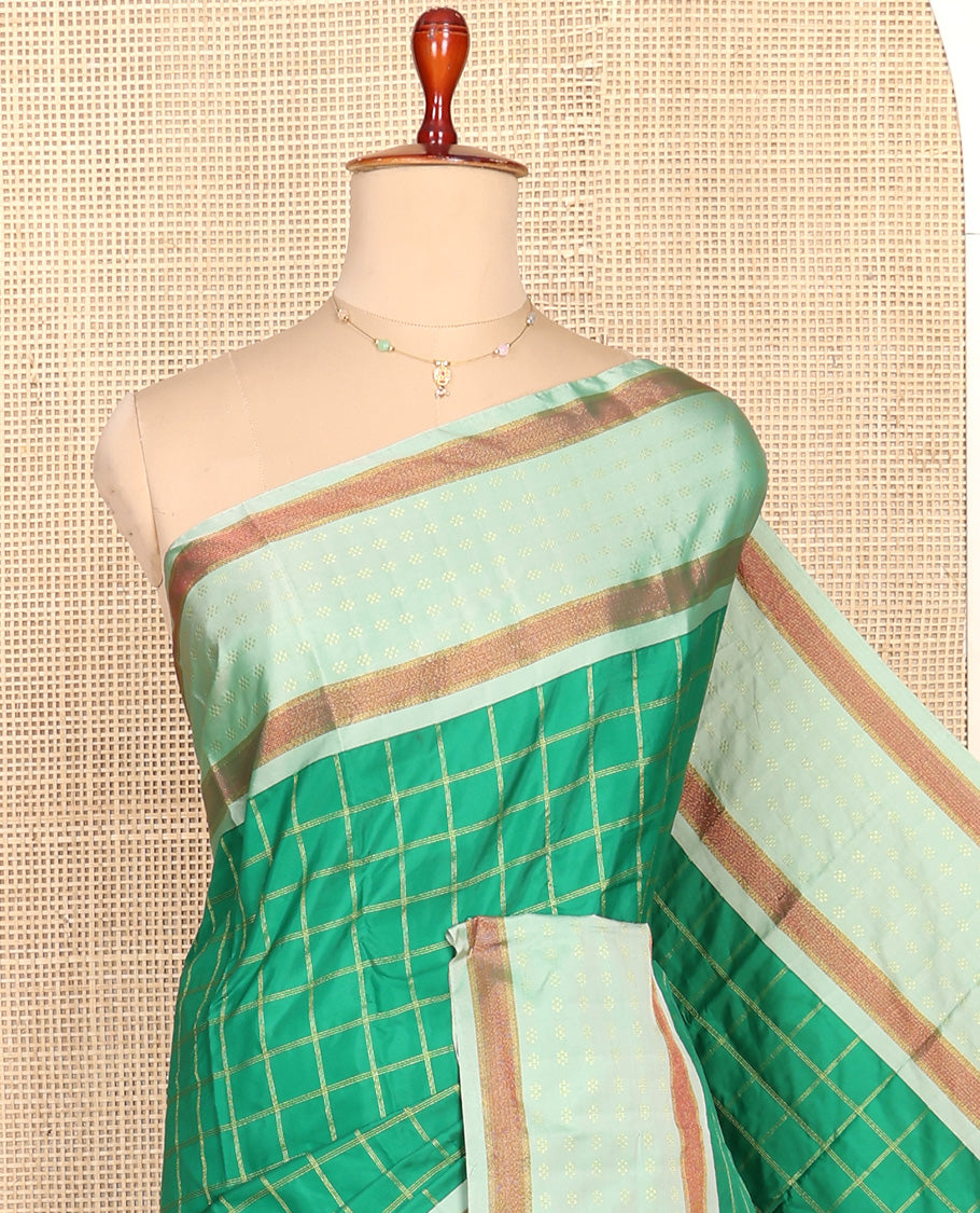 Green Aarani Silk Saree, Spotlighted with Zari Medium-Sized Checked All Over Its Body, Complemented by a Contrast Zari Buttas Woven Border, Pallu of Stripes, and Paired with a Matching Blouse