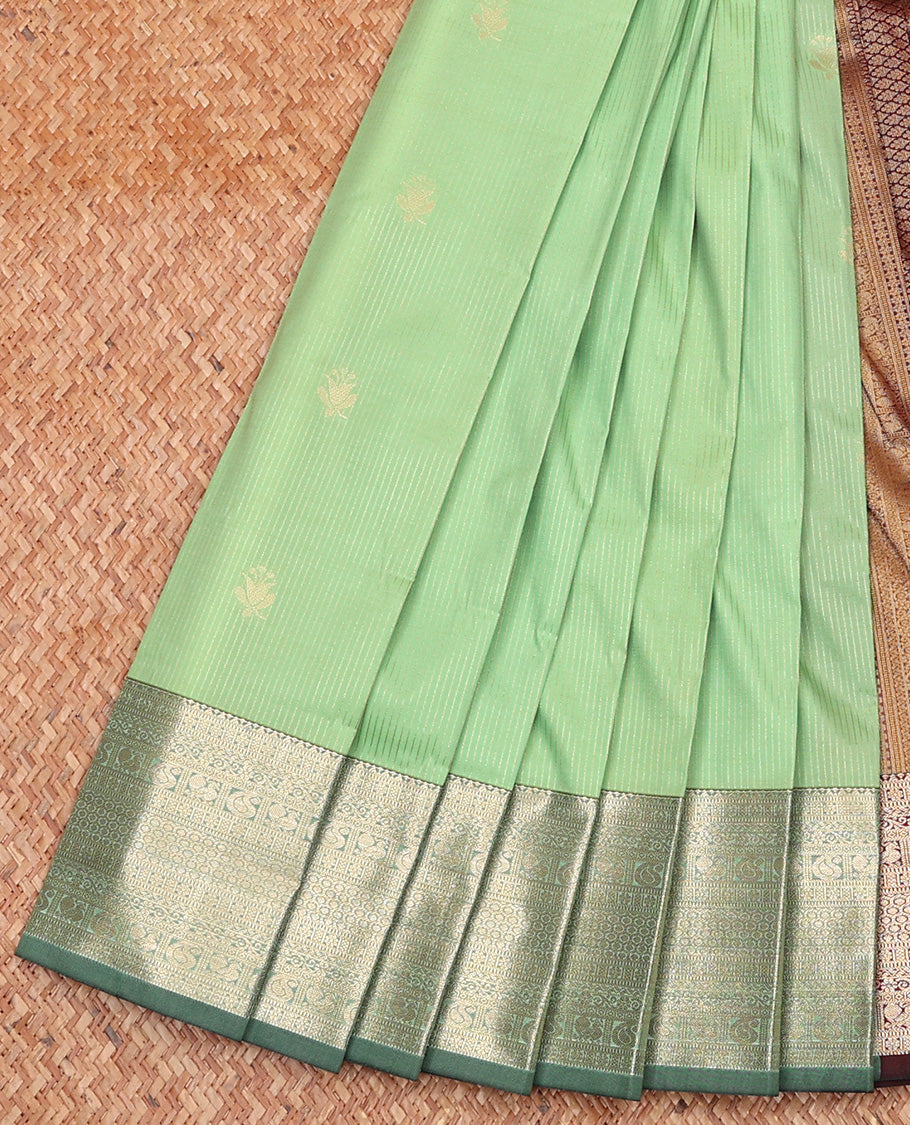 Pista Green Budget Silk Saree Subtly Sparkled With Zari Buttas and Stripes All Over Its Body, Complemented by Contrast Traditional Zari Designs Woven Border, Grandly Decked Up Pallu and Paired with a Contrast Blouse