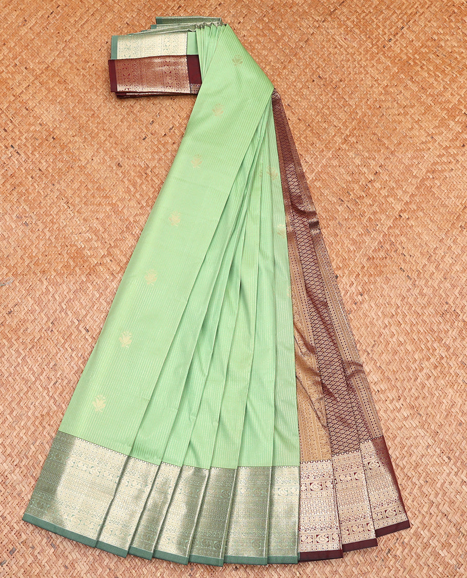 Pista Green Budget Silk Saree Subtly Sparkled With Zari Buttas and Stripes All Over Its Body, Complemented by Contrast Traditional Zari Designs Woven Border, Grandly Decked Up Pallu and Paired with a Contrast Blouse