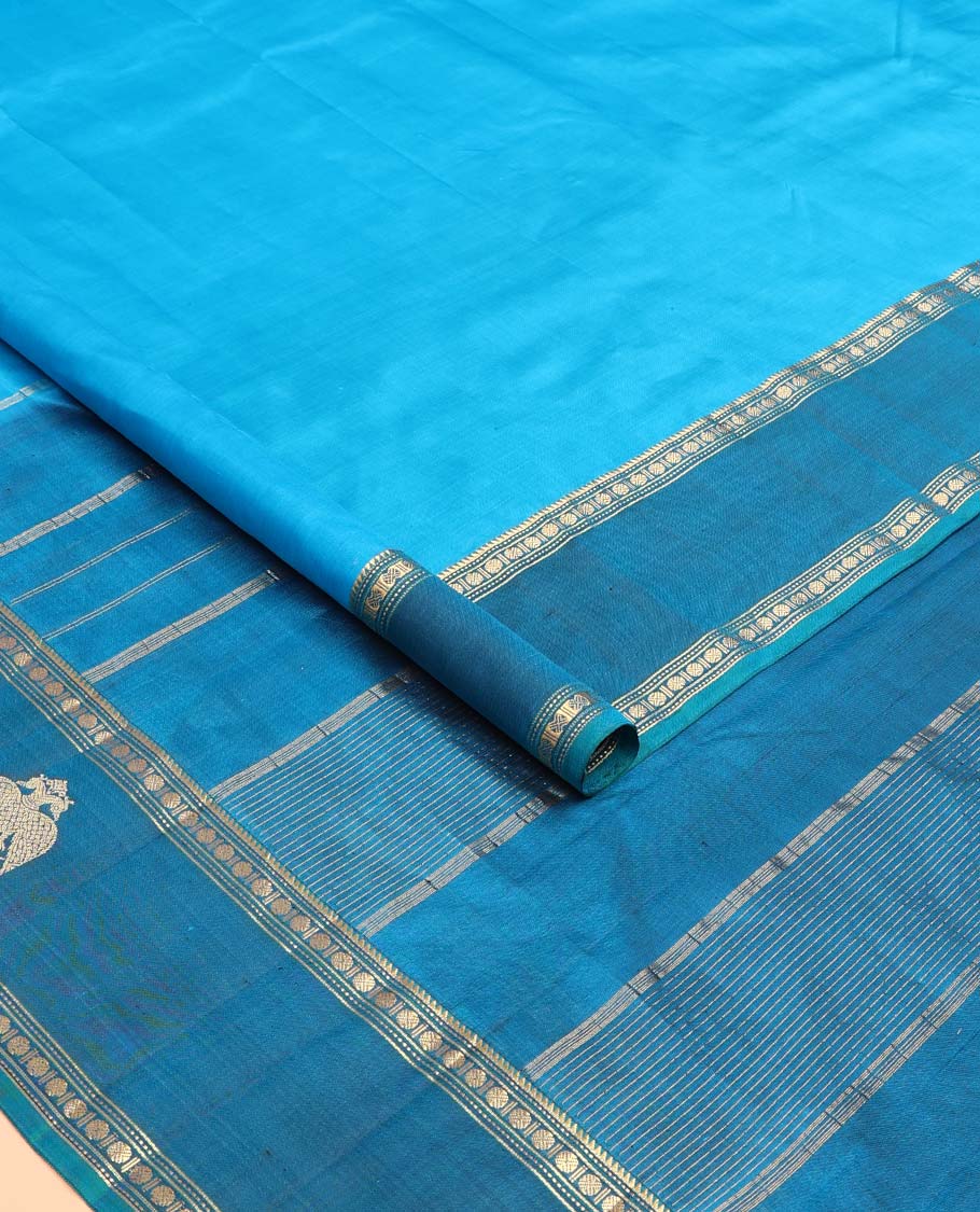 Blue plain Kanchipuram silk saree, contrast border of rekku, muthu, rudraksham and iruthalai pakshi motifs, and zari striped pallu