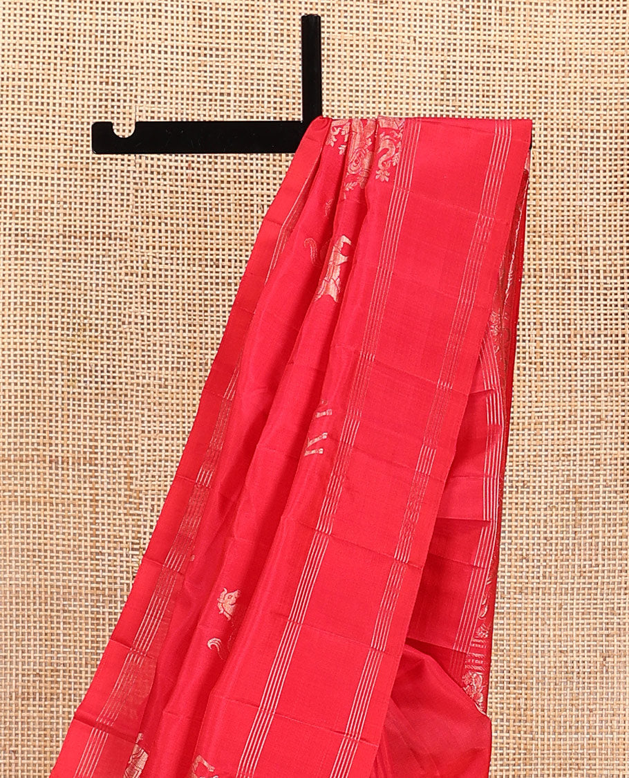 Red kuthirai buttas soft silk saree, zari border, and pallu of floral, house, and elephant motifs