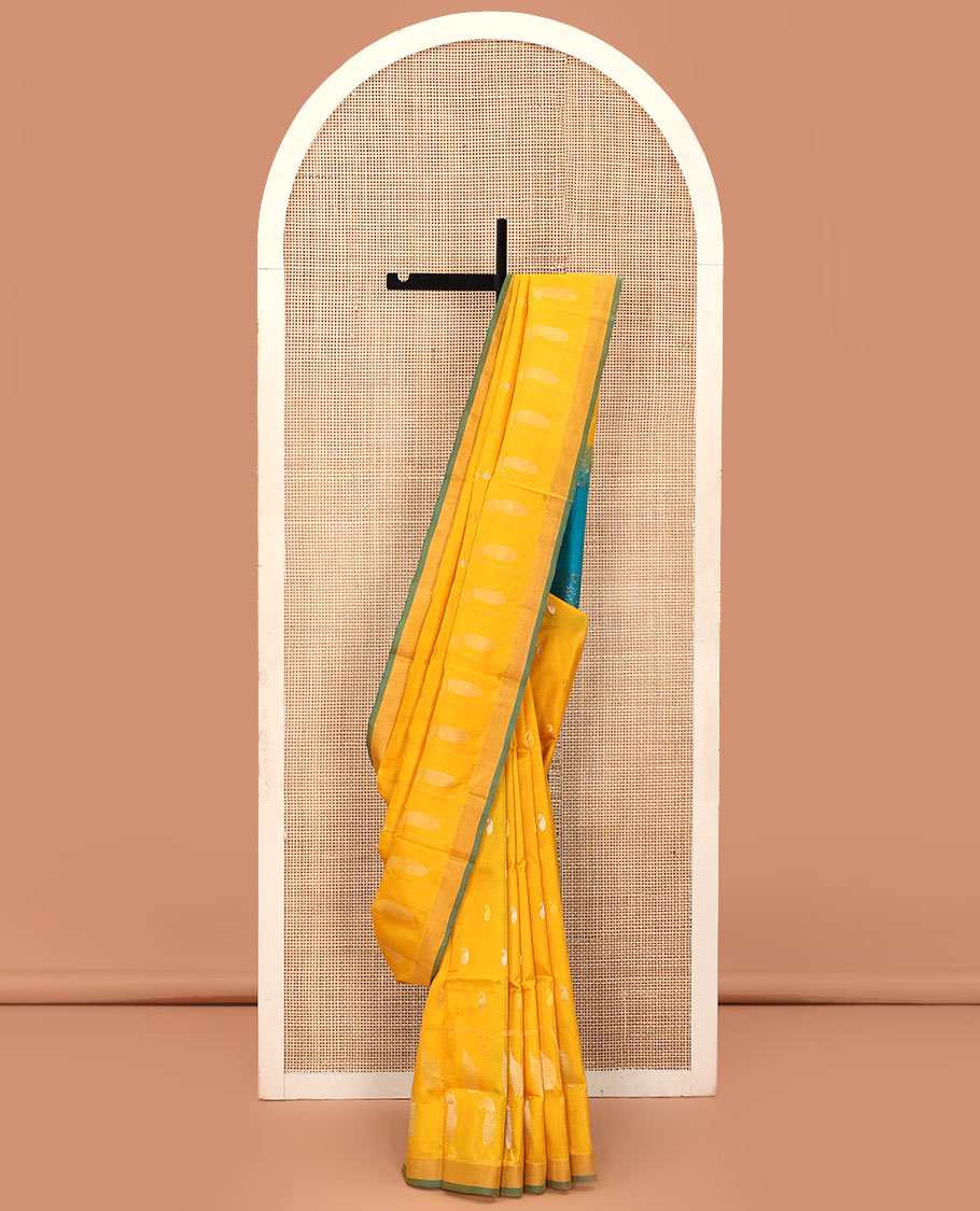 Yellow Uppada Silk Saree Gracefully Embellished with Zari Buttas and Paisley Buttas, Subtle Bavanji Border, Complemented by Contrast Pallu of Peacock Designs, and Paired with a Contrast Blouse