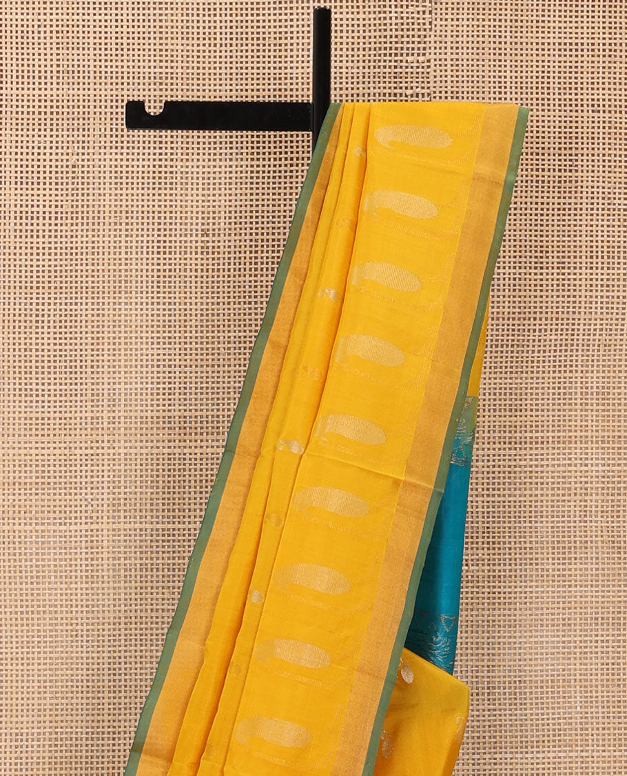 Yellow Uppada Silk Saree Gracefully Embellished with Zari Buttas and Paisley Buttas, Subtle Bavanji Border, Complemented by Contrast Pallu of Peacock Designs, and Paired with a Contrast Blouse