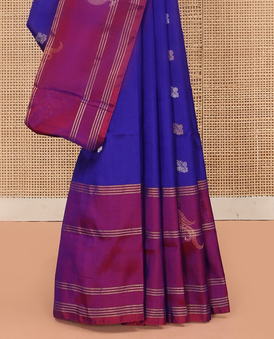 Blue Uppada Silk Saree Enlivened With Zari Buttas, Captivating Contrast Border Featuring Zari Stripes And Peacock Motifs, Pallu Depicting Rose Flower-Enclosed Mughal-Style Arches, And Paired With A Contrast Blouse