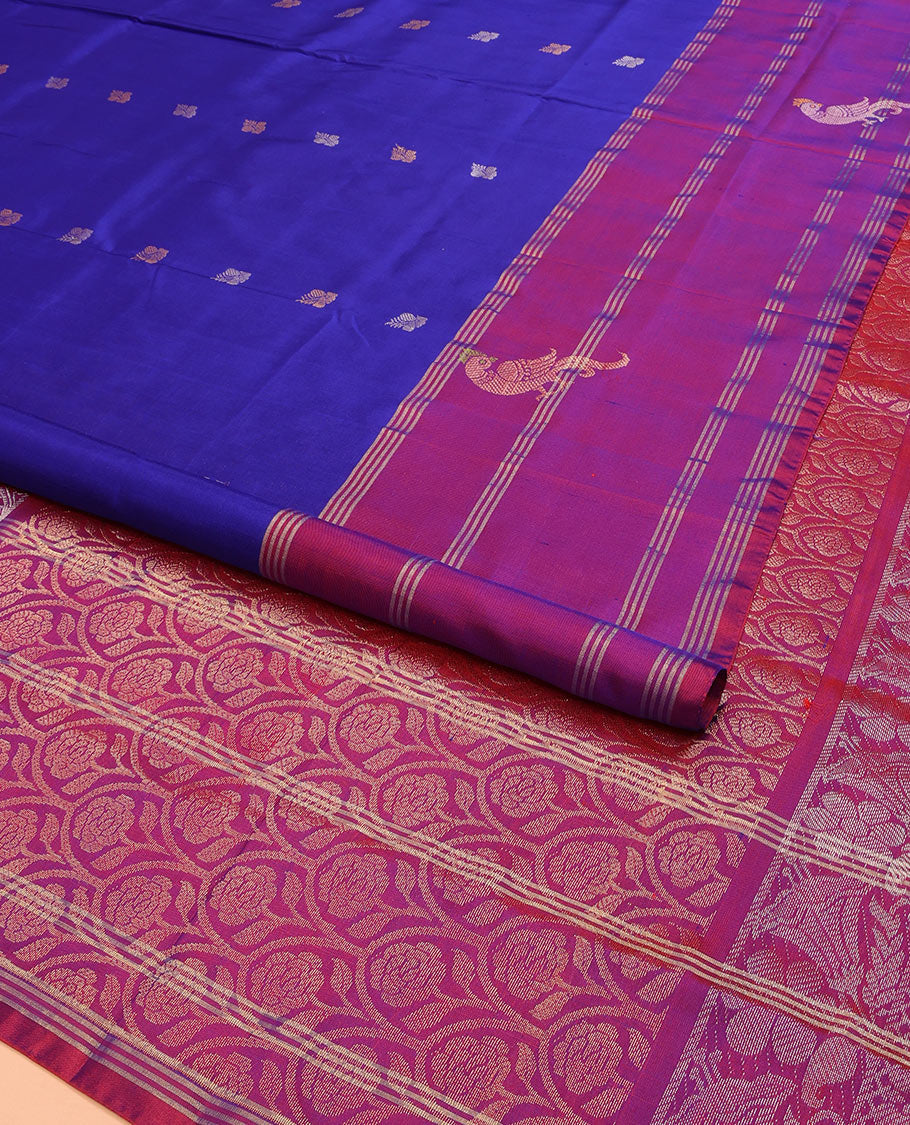Blue Uppada Silk Saree Enlivened With Zari Buttas, Captivating Contrast Border Featuring Zari Stripes And Peacock Motifs, Pallu Depicting Rose Flower-Enclosed Mughal-Style Arches, And Paired With A Contrast Blouse