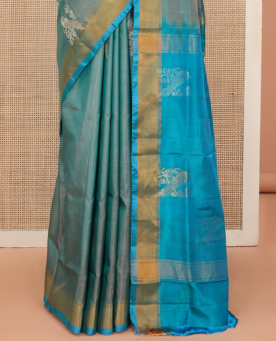Blue Uppada Silk Saree Accentuated with Parrot Zari Buttas, Complemented by Bavanji Border, Contrast Pallu Steeped with Parrot Zari Designs, and Paired with a Contrast Blouse