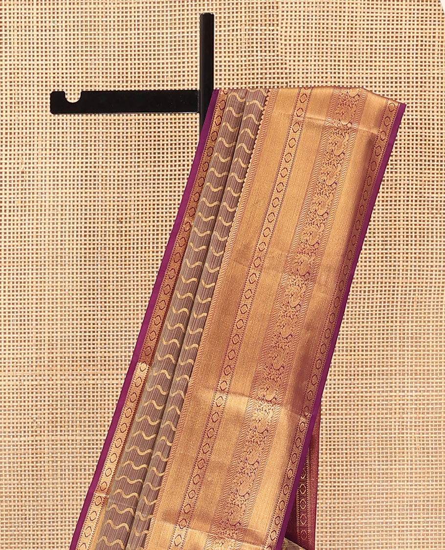 Brown Vasundhara Lite Silk Mix Saree Showcasing Zig-Zag Stripes Across the Body, Enhanced by a Contrast Border Adorned with Rekku, Puli Nagam, Laddu Kamalam, and Mayil Motifs, Complemented with a Zari-Woven Pallu and a Contrast Blouse