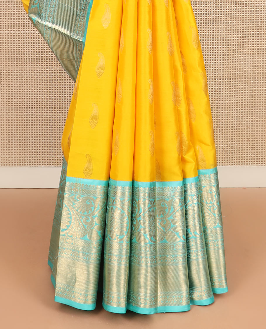 Yellow zari buttas silk saree, contrast border of thilakam, poun, kodi visiry, mayil kann, neli, and kathir designs, and butta enclosed checked pallu