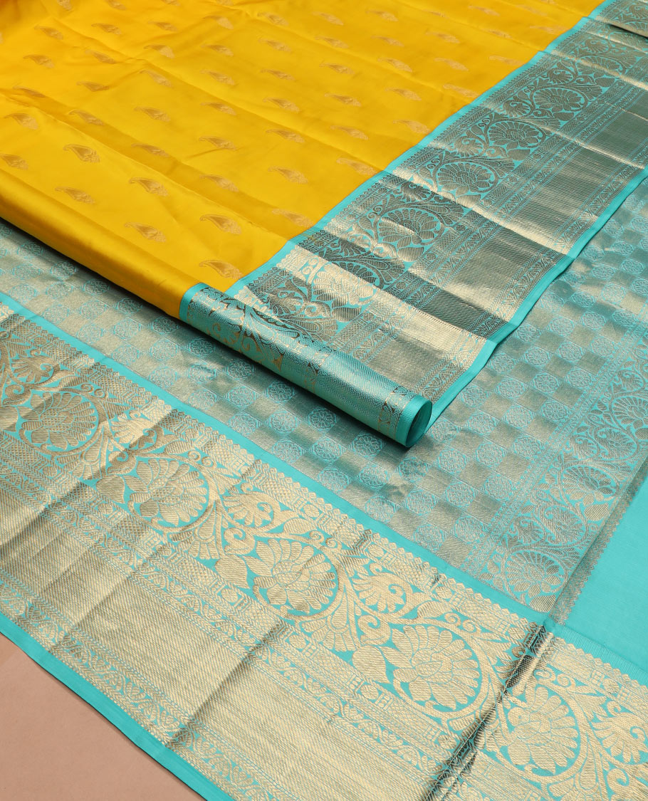 Yellow zari buttas silk saree, contrast border of thilakam, poun, kodi visiry, mayil kann, neli, and kathir designs, and butta enclosed checked pallu