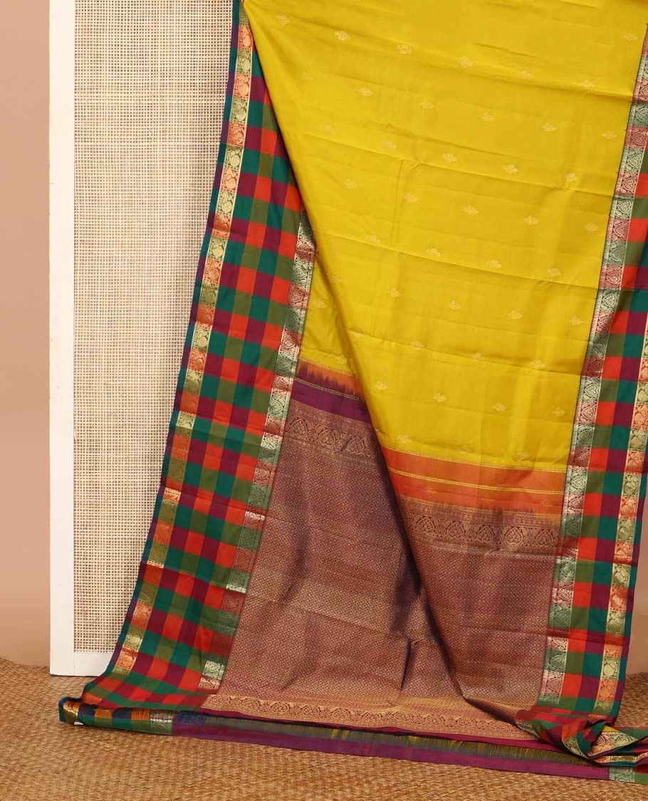 Yellow zari buttas Kanchipuram silk saree, contrast multi-color checked border of jadai nagam, and mayil designs, and contrast zari-rich jaal pallu