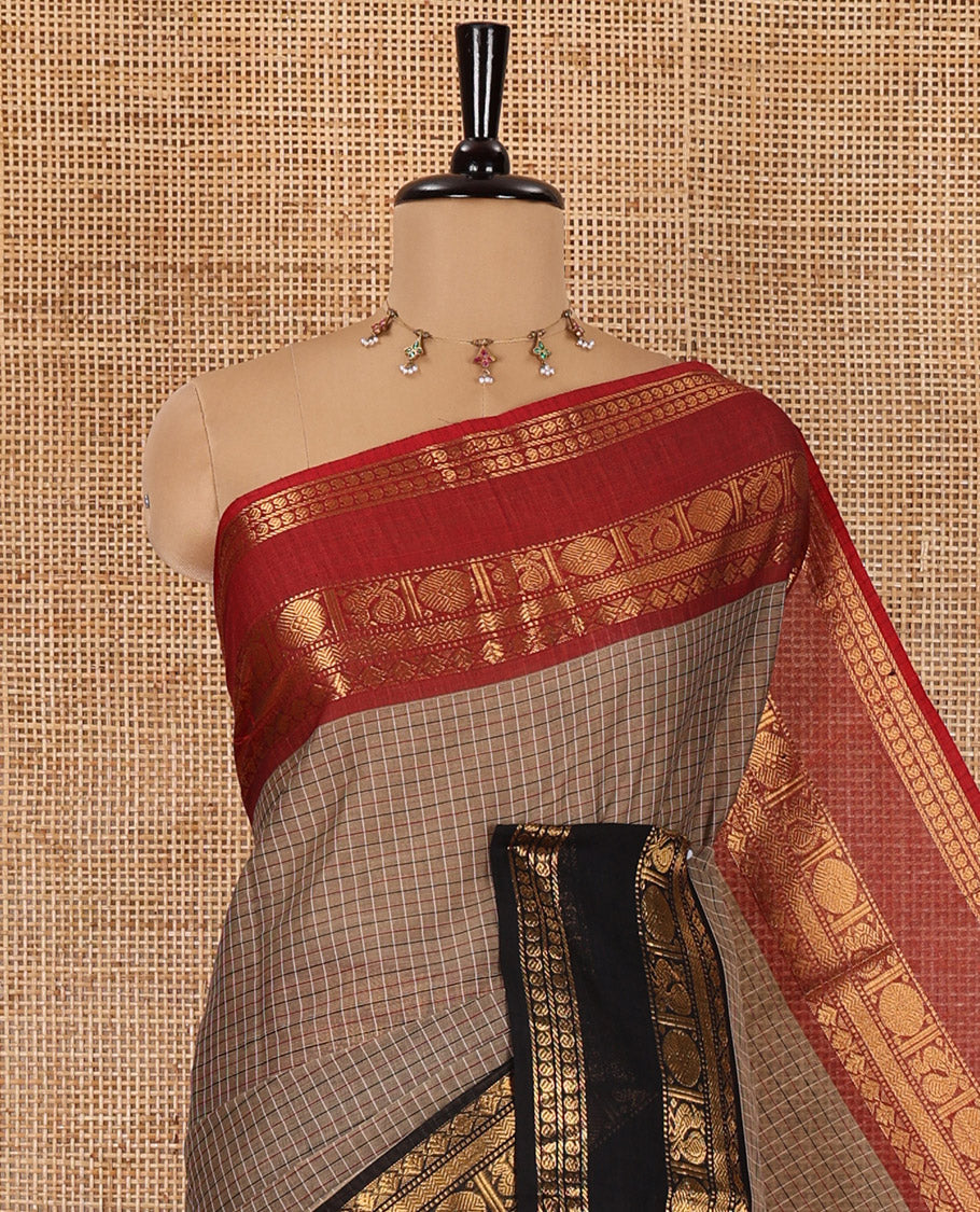 Beige Checked Chettinad Cotton Saree, Adorned with Contrast Ganga Jamuna Rettai Pettu Peacock Chakram Border, Subtly Zari Striped Pallu, and a Matching Blouse