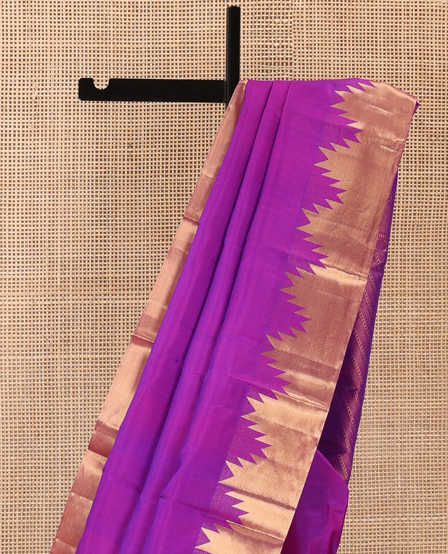 Rani pink plain Kanchipuram silk saree, thazampoo rekku zari border, and diagonally woven geometric patterned pallu