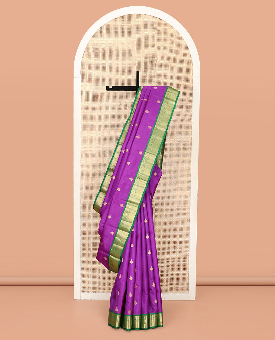 Purple Vasundhara Silk Saree, Ornamented with Zari Buttas All Over Its Body, Complemented by a Contrast Border of Rekku, Muthu, and Kodi Visiry Designs, Grand Pallu Steeped with Manga Designs, and Paired with a Contrast Blouse