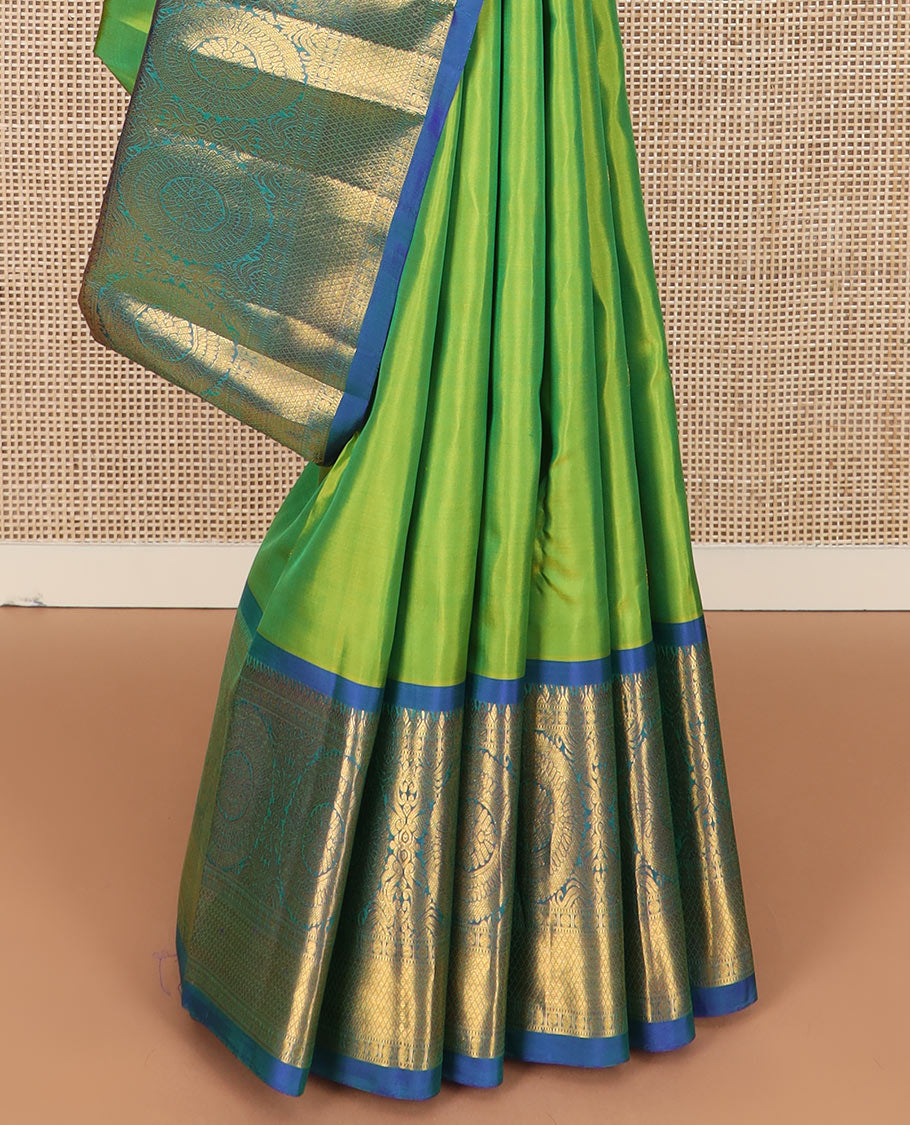 Green chakram buttas Kanchipuram silk saree, contrast border of muthu, rudraksham, poo chakram, and mayil kann designs, and chakram motifs pallu