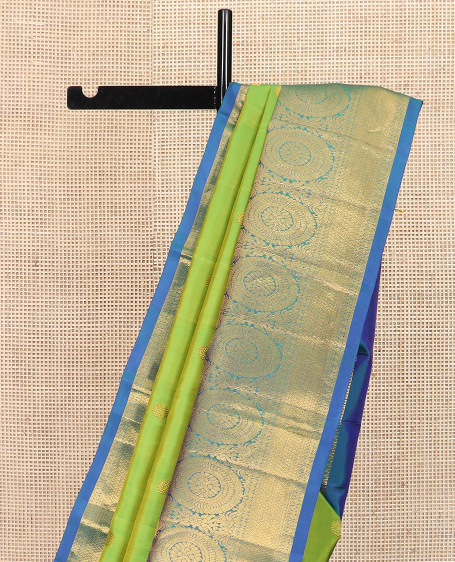 Green chakram buttas Kanchipuram silk saree, contrast border of muthu, rudraksham, poo chakram, and mayil kann designs, and chakram motifs pallu