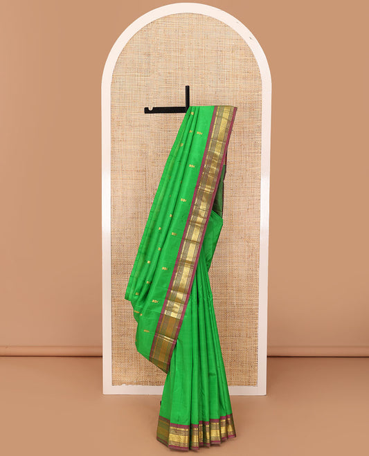 Green zari buttas Kanchipuram silk saree, contrast one-sided border of thilakam mokku,muthu & jaal & zari design pallu