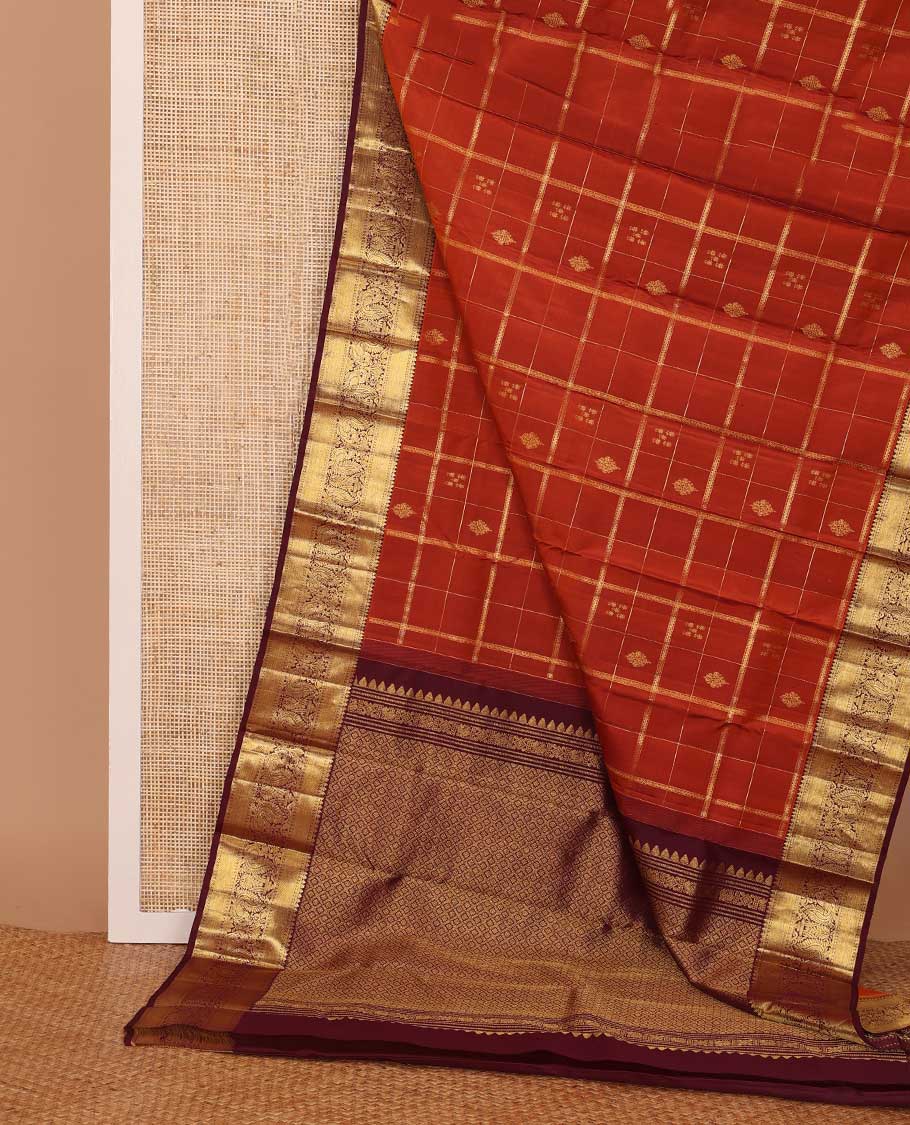 Orange zari buttas and checked Kanchipuram silk saree,contrast border of thilakam,banaras and mayil designs, and jaal pallu