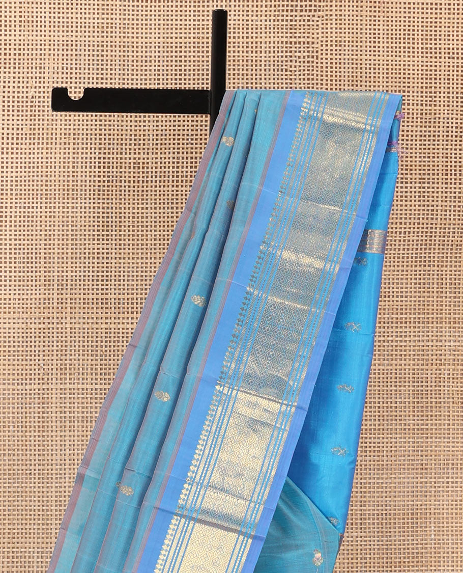 Blue zari buttas Kanchipuram silk saree, contrast one-sided border of panner sombu, muthu, banaras, and jaal, and zari woven pallu