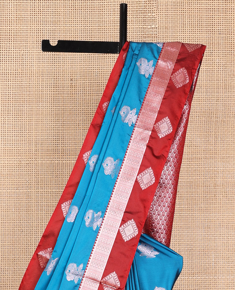 Blue semi-soft silk saree with zari buttas, contrast diamond design border & intricate pallu