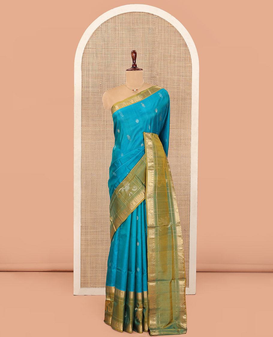 Blue Uppada Silk Saree Graced with Zari Buttas, Complemented by a Contrast Traditional Zari Border of Peacock Veena Designs, Contrast Pallu of Floral Jaal Designs, and Paired with a Contrast Blouse