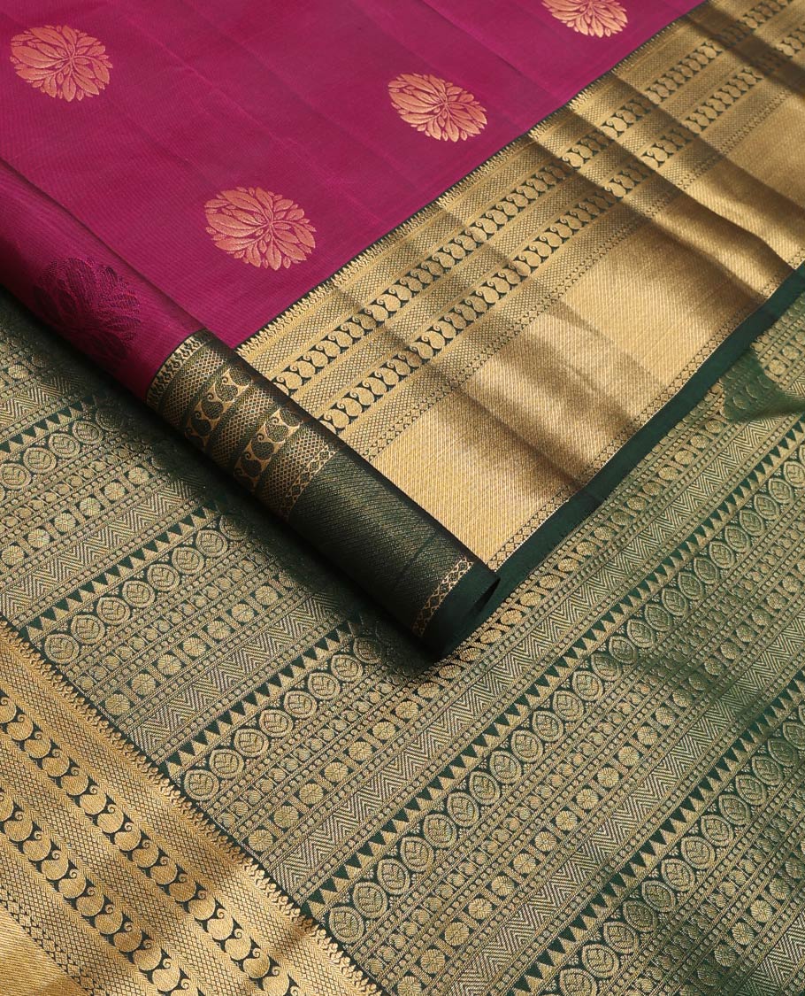 Magenta zari buttas Vasundhara silk mix saree, contrast border of thilakam, mayil kann, diamond, and manga designs, and geometric patterned pallu