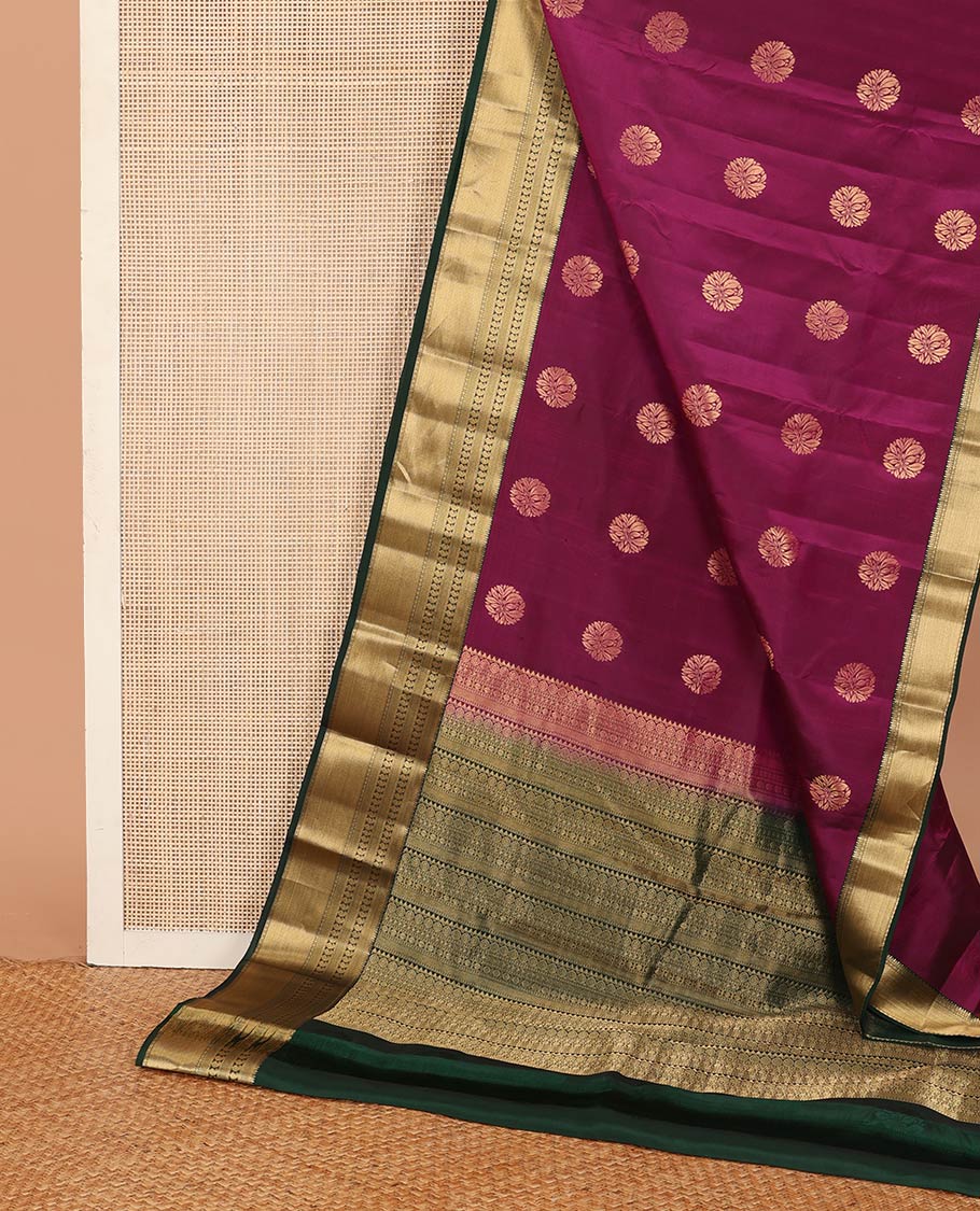 Magenta zari buttas Vasundhara silk mix saree, contrast border of thilakam, mayil kann, diamond, and manga designs, and geometric patterned pallu