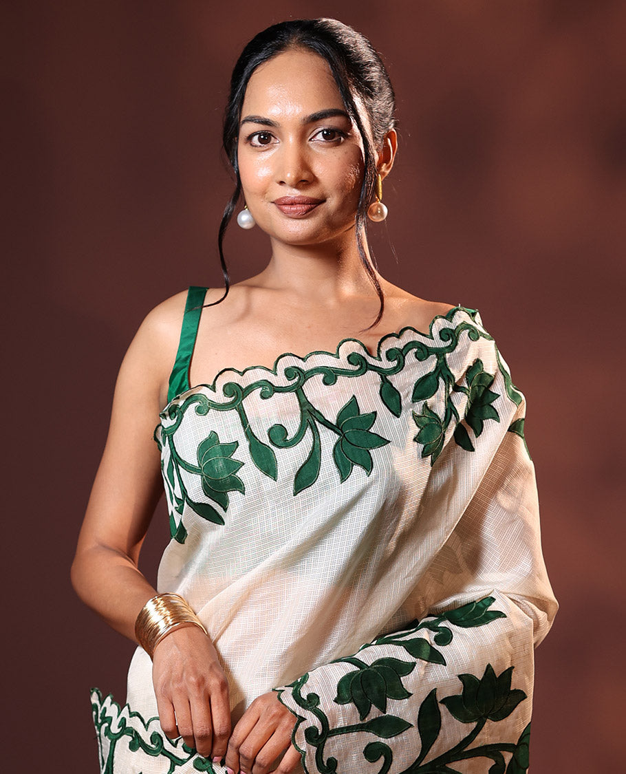 Cream and Green Plain Fancy Kota Silk Saree Highlighted with Lotus Floral Applique Embroidered Scallop Border, Lotus Motifs Applique Embroidered Pallu, and a Contrast Plain Blouse
