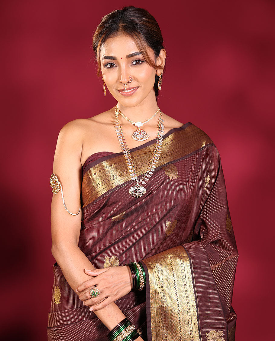 Chocolate Brown Budget Silk Saree, Elevated with Muthu Stripes, and Peacock Buttas on Its Body, Highlighted by a Traditional Zari Design Border, Pallu Delicately Woven with Floral Jaal Designs, and Paired with a Matching Blouse