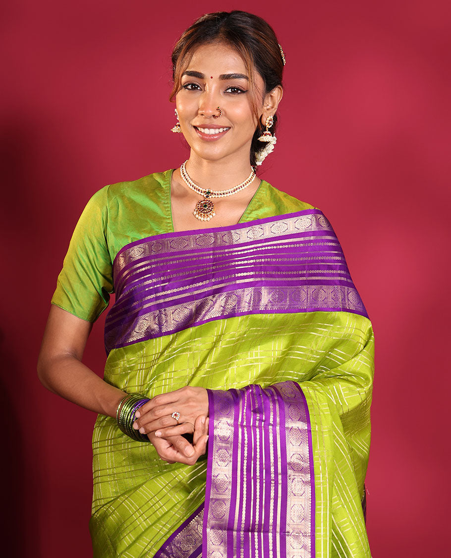 Green Vasundhara Silk Saree, Spotlighted with Zari Checked Design All Over Its Body, Complemented by a Contrast Varisai Pettu Border of Muthu, Poun, and Chakram Designs, Grandly Embellished Pallu of Jaal Designs, and Paired with a Contrast Blouse