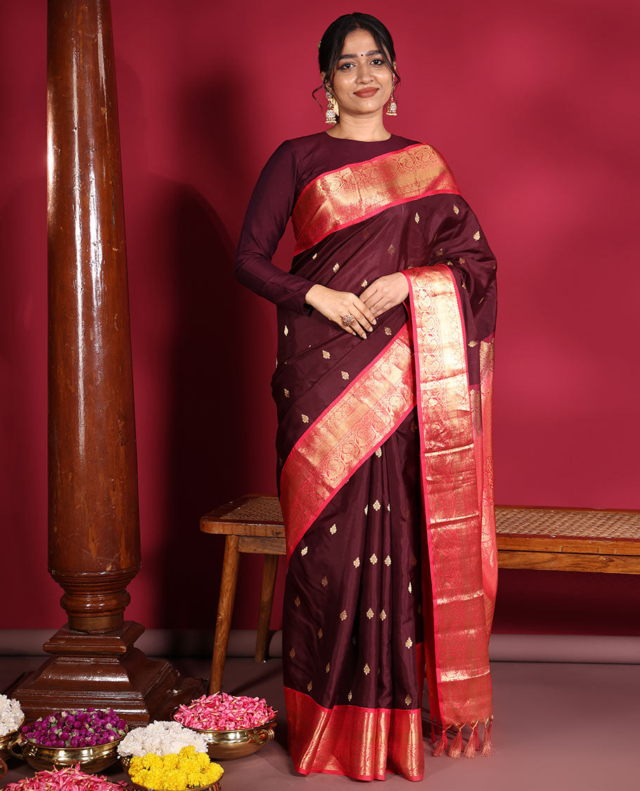 Brown Vasundhara Silk Saree, Decorated with Zari Buttas on Its Body, Complemented by a Contrast Traditional Zari Border of Mayil Designs, Grand Pallu Depicts Jaal and Floral Designs, and Paired with a Contrasting Blouse