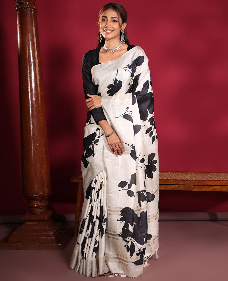 Cream Fancy Tussar Saree, Artfully Detailed with Silhouette-Style Floral Motifs Printed on Its Body, Subtle Zari-Textured Border, Pallu Pictures the Same Floral Print, and Paired with a Matching Blouse