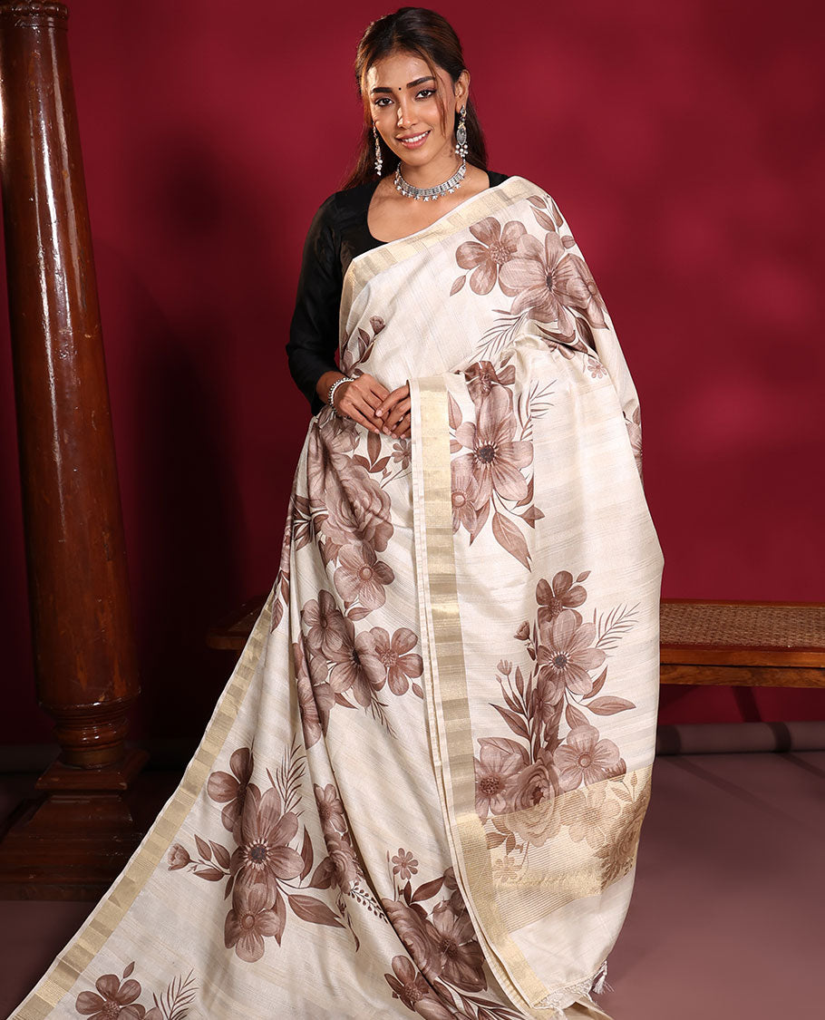 Cream Fancy Tussar Saree, Finely Detailed with Brownish Floral Motifs Printed on Its Body, Subtle Zari-Bavanji Border, Pallu Pictures Floral Print and Gleaming Zari Stripes, and Paired with a Matching Blouse