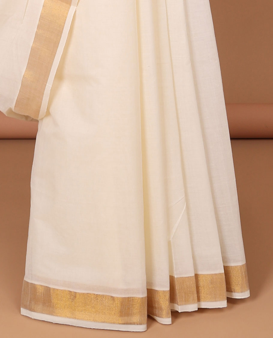 Cream kerala saree, zari border & pallu of peacock zari designs